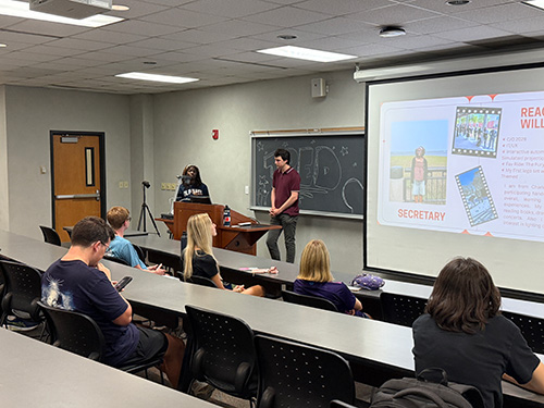 A student giving a presentation at the podium at a TPE event