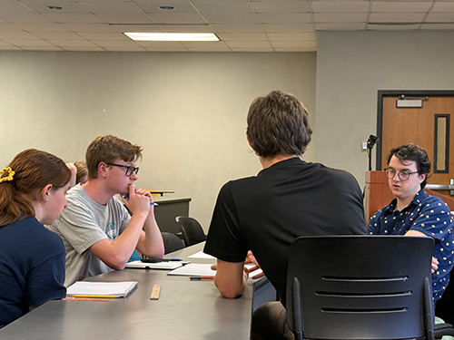Students engaged in a group discussion at a TPE event