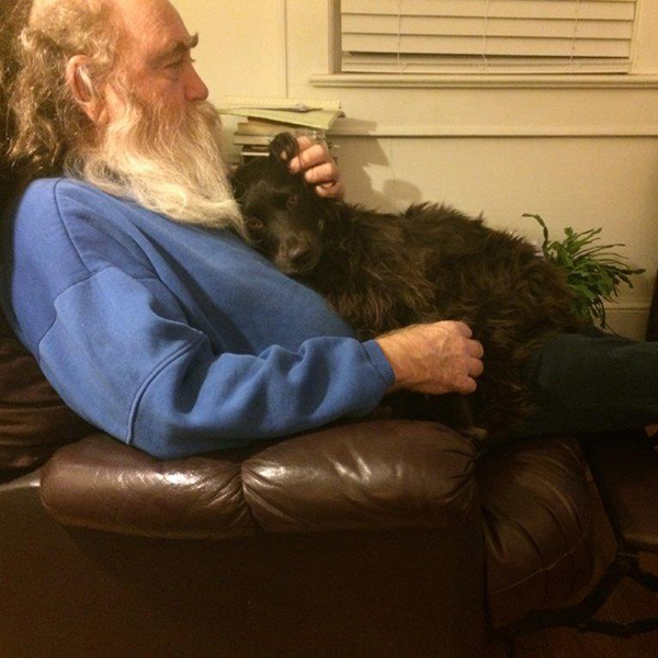 Dr Wally Peters in a recliner with his dog